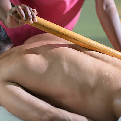Young man receiving a bamboo massage